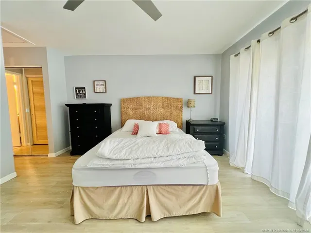 a bedroom with a bed a table and book shelfs