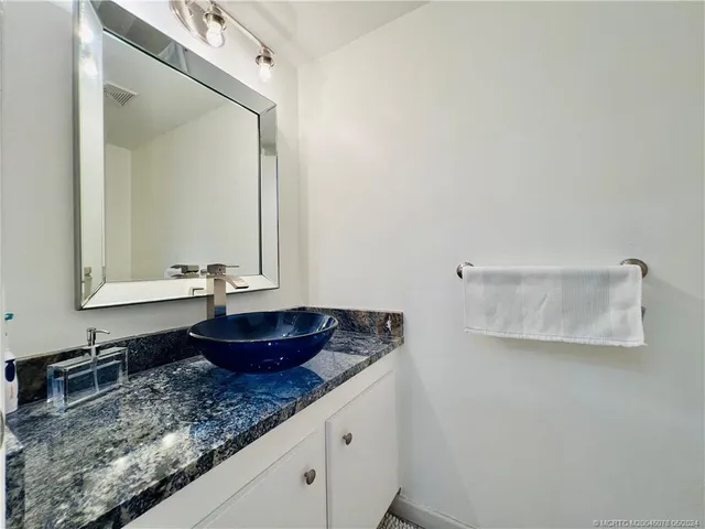 a white toilet sitting next to a white wall