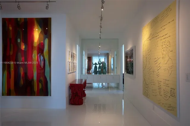 a bedroom with a bed a mirror and a large window