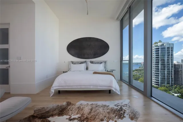 a view of a swimming pool with lawn chairs under an umbrella