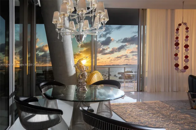 a view of a dining room with furniture wooden floor and floor to ceiling window