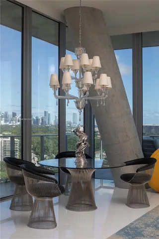 a living room with furniture and a floor to ceiling window