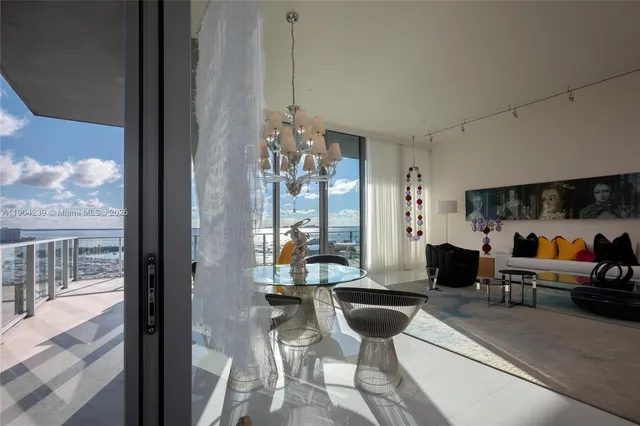 a view of a dining room with furniture and a chandelier