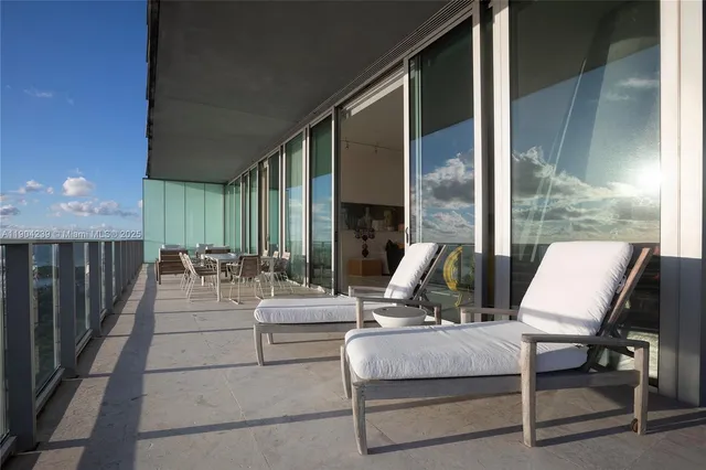 a view of a dining room with furniture and a chandelier