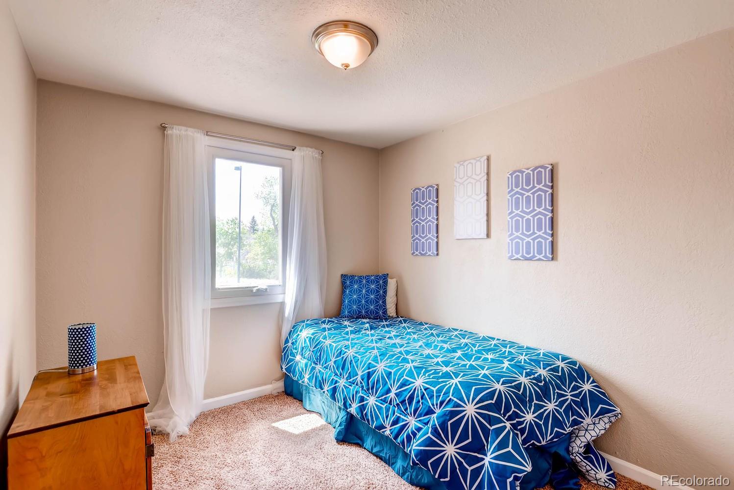 1760 South Java Way Denver, CO 80219 - Photo 16 of 28 a bedroom with a bed and a window