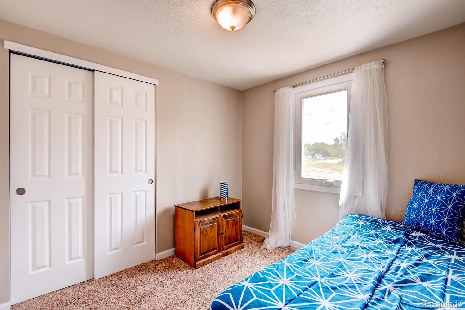 1760 South Java Way Denver, CO 80219 - Photo 17 of 28 a bedroom with a bed and a window