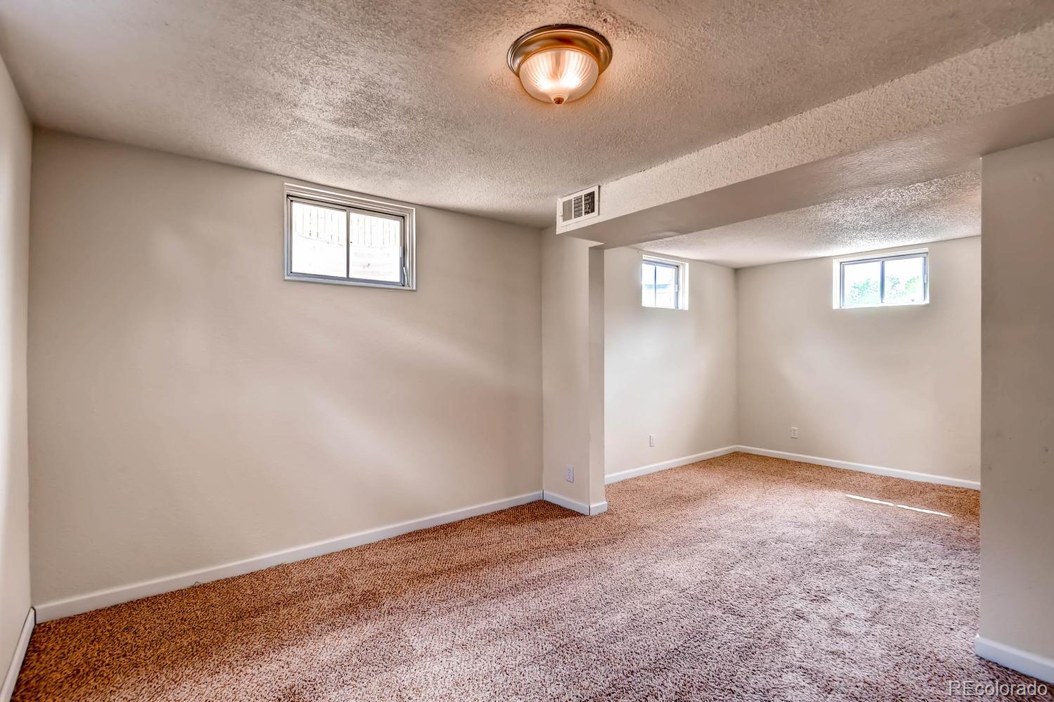 1760 South Java Way Denver, CO 80219 - Photo 18 of 28 an empty room with a empty space and windows