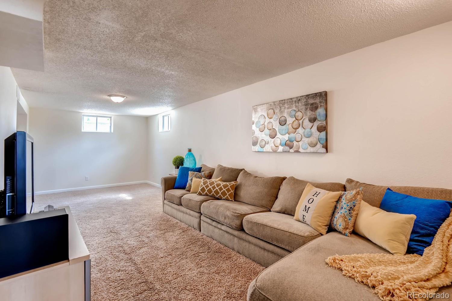 1760 South Java Way Denver, CO 80219 - Photo 20 of 28 a living room with furniture and a couch