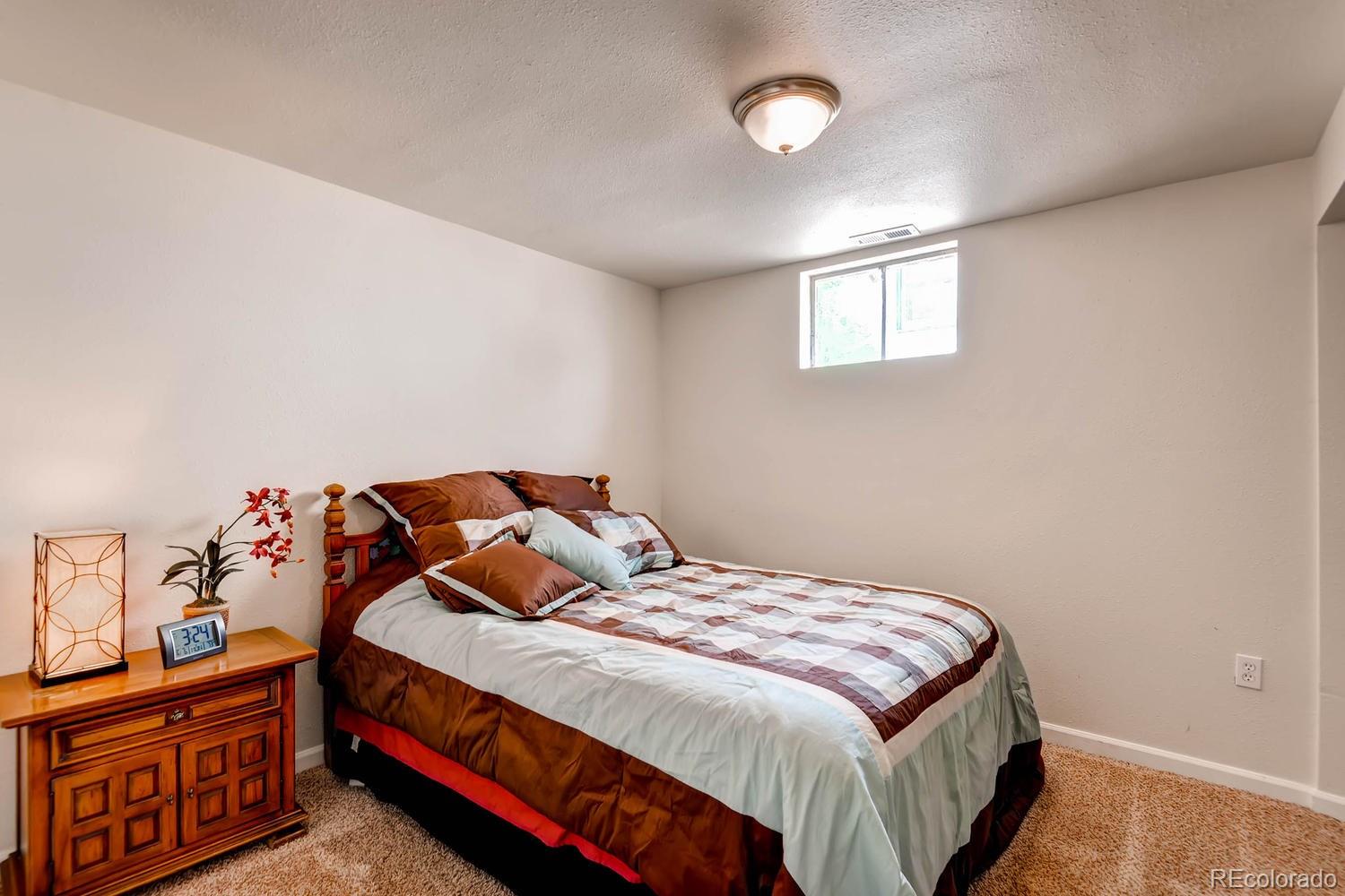 1760 South Java Way Denver, CO 80219 - Photo 21 of 28 a bedroom with a bed and a window