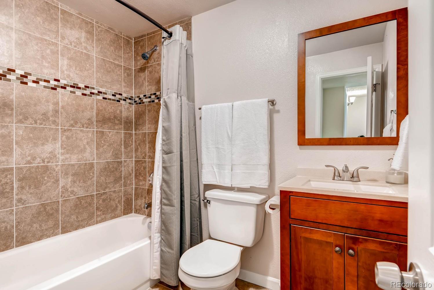 1760 South Java Way Denver, CO 80219 - Photo 23 of 28 a bathroom with a sink toilet and shower