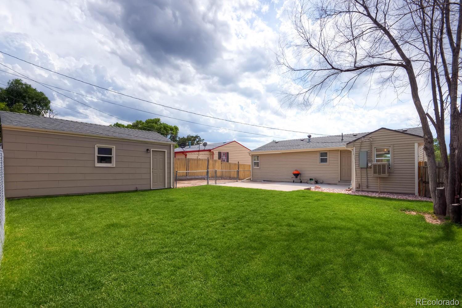 1760 South Java Way Denver, CO 80219 - Photo 26 of 28 a backyard of a house with table and chairs