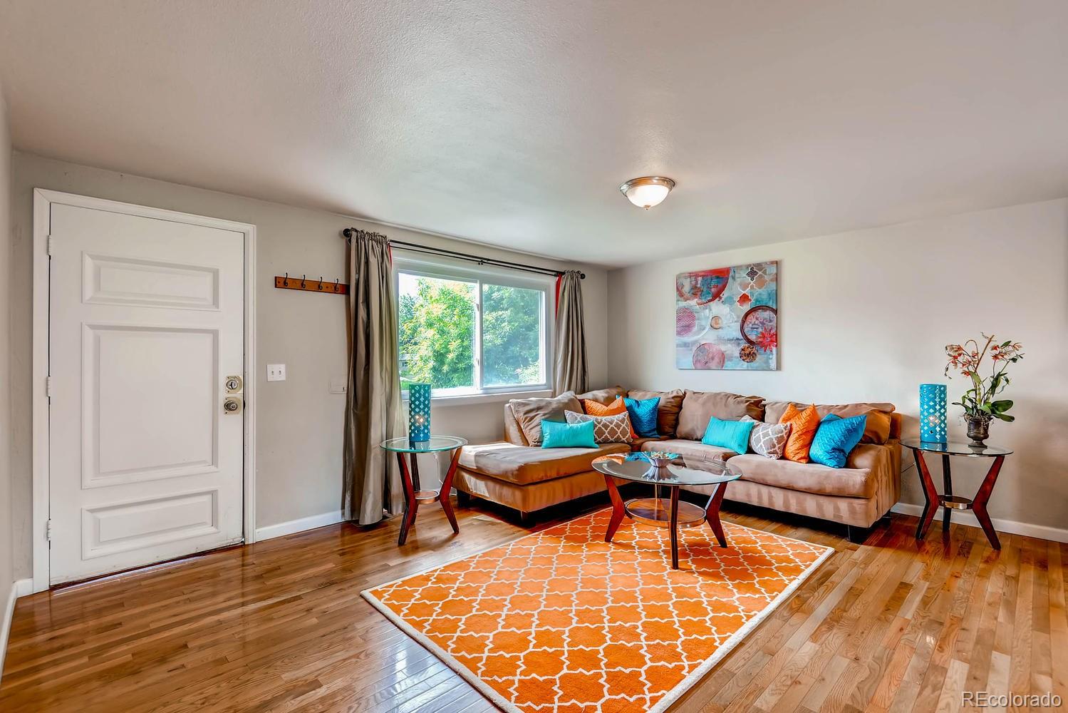 1760 South Java Way Denver, CO 80219 - Photo 4 of 28 a living room with furniture and wooden floor