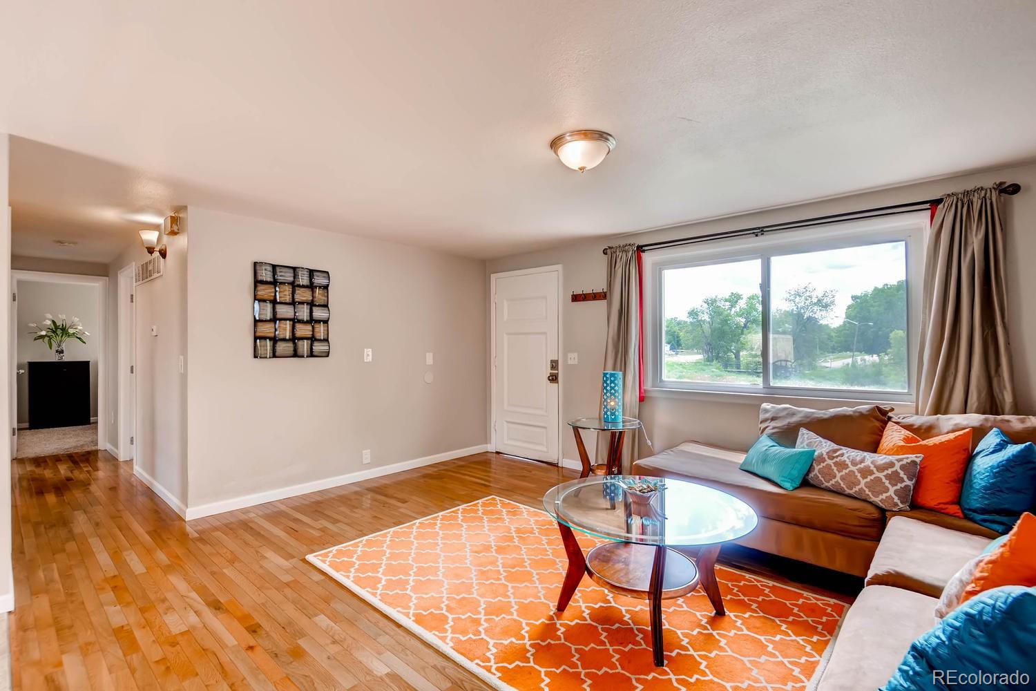1760 South Java Way Denver, CO 80219 - Photo 5 of 28 a living room with furniture and a window