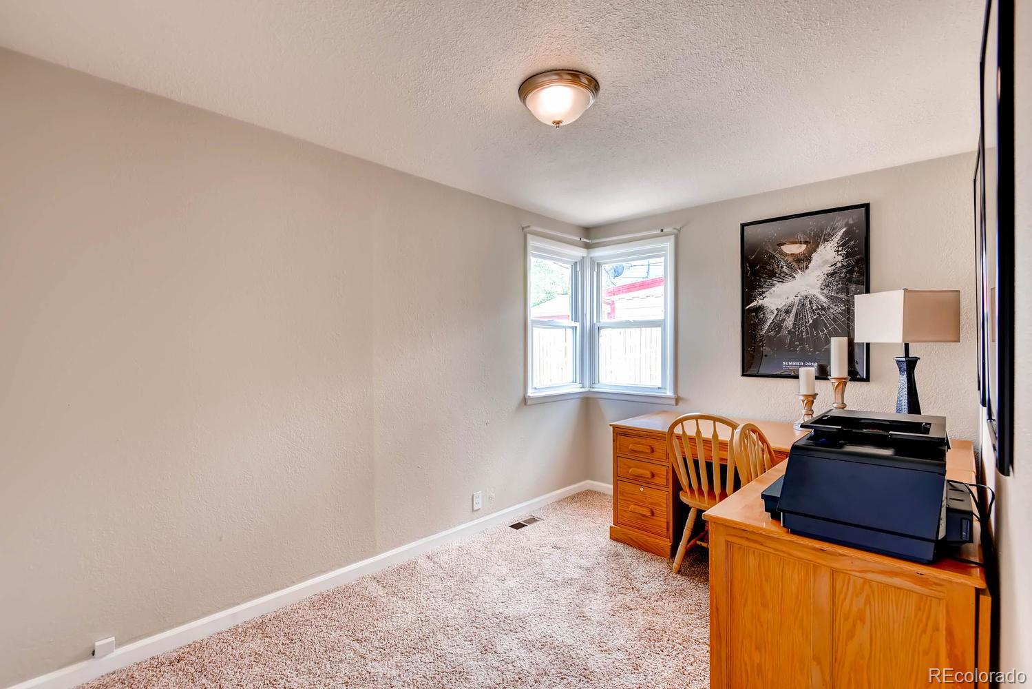 1760 South Java Way Denver, CO 80219 - Photo 7 of 28 a bedroom with furniture and windows