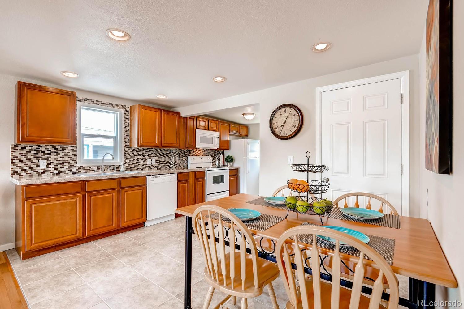 1760 South Java Way Denver, CO 80219 - Photo 8 of 28 a bedroom with a bed and a sink