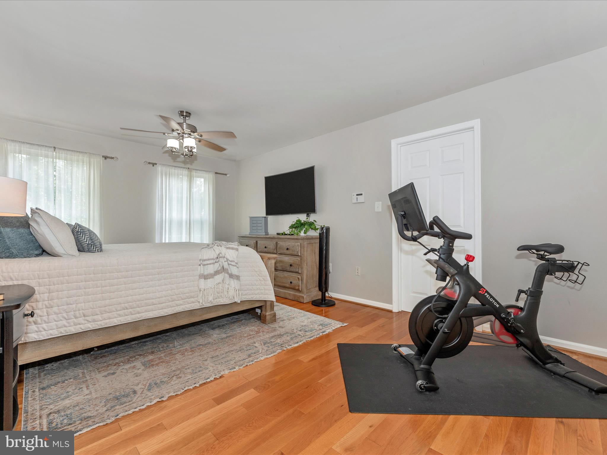 8930 Indian Springs Road Frederick, MD 21702 - Photo 34 of 69 a bedroom with a bed gym equipment and a flat screen tv