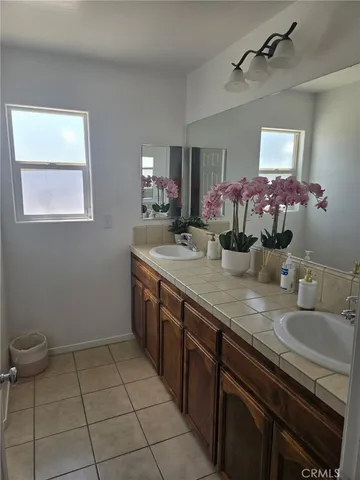 a bathroom with a sink a vanity and a mirror