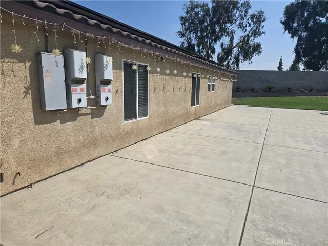 a view of a patio with table and chairs and wooden fence
