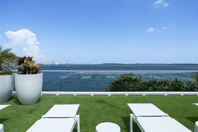 a view of a patio with couches chair and potted plants