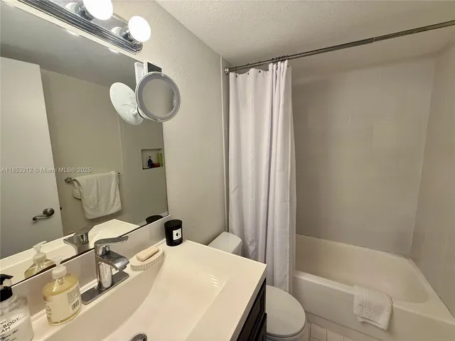 an aerial view of a house with a swimming pool and outdoor seating