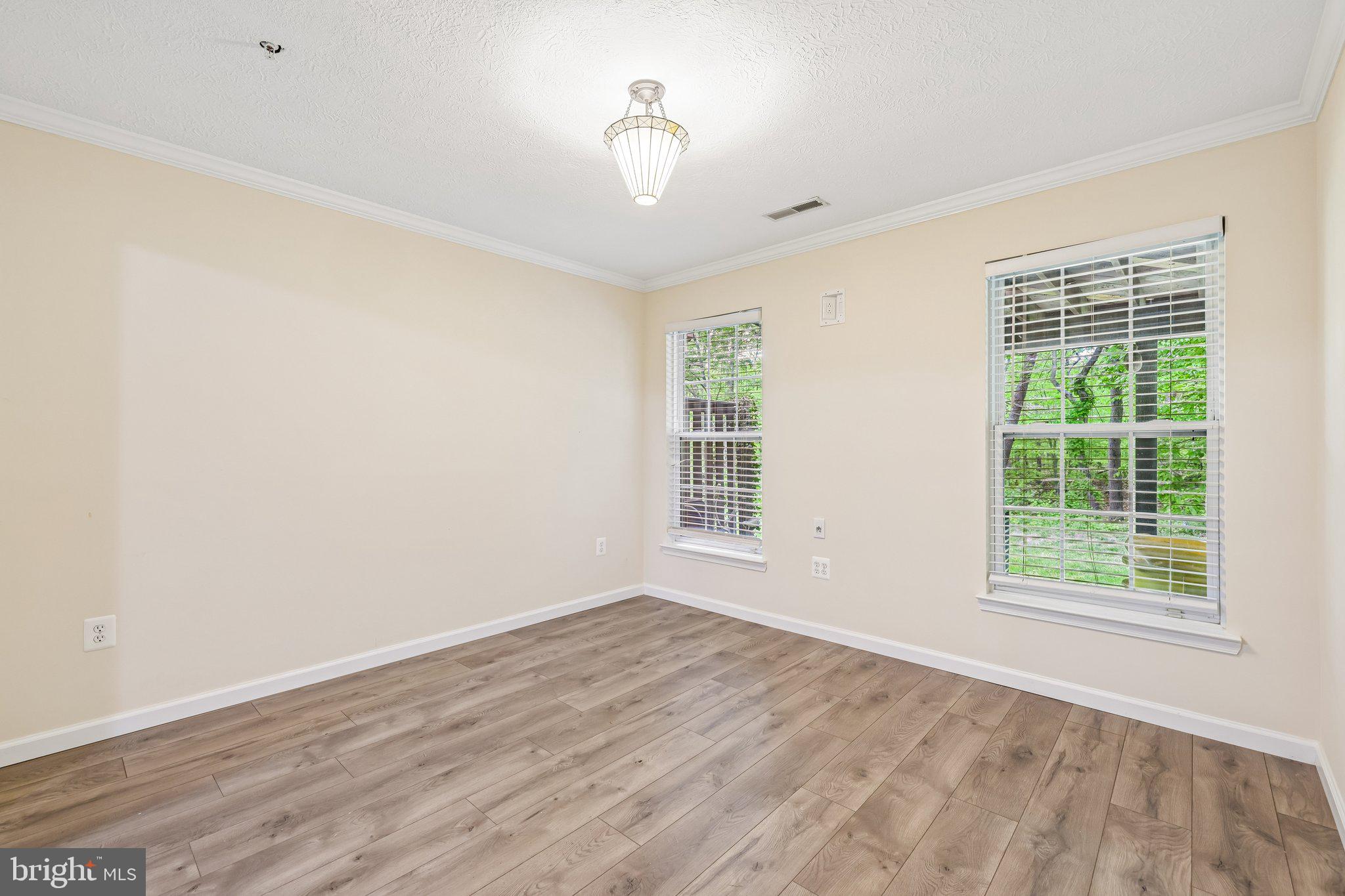 8727 Thornbrook Drive Odenton, MD 21113 - Photo 15 of 40 an empty room with wooden floor and windows