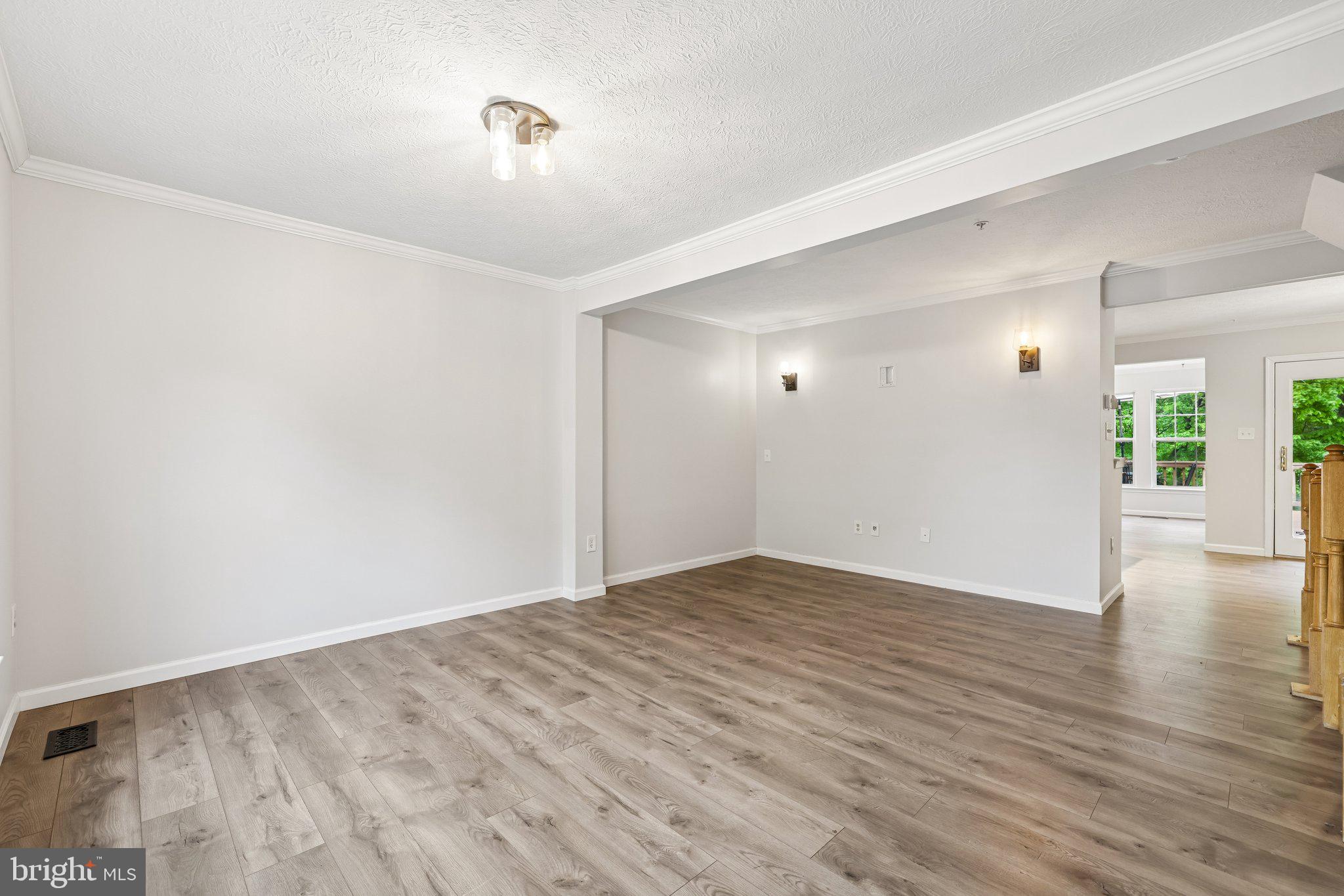 8727 Thornbrook Drive Odenton, MD 21113 - Photo 2 of 40 a view of an empty room with wooden floor and a window