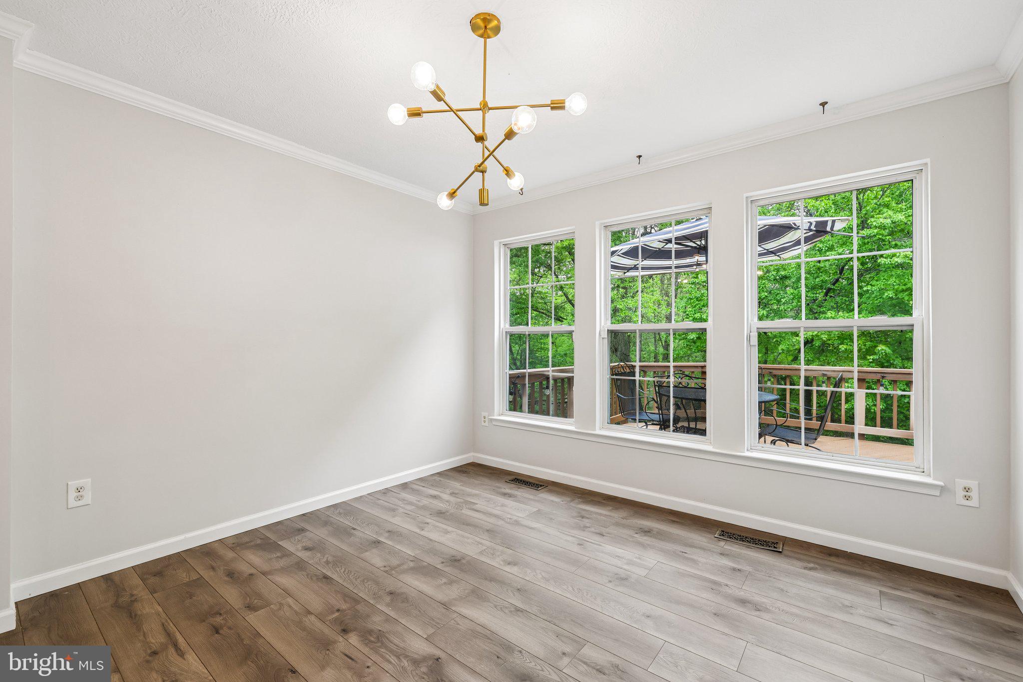8727 Thornbrook Drive Odenton, MD 21113 - Photo 21 of 40 a view of an empty room with wooden floor and a window