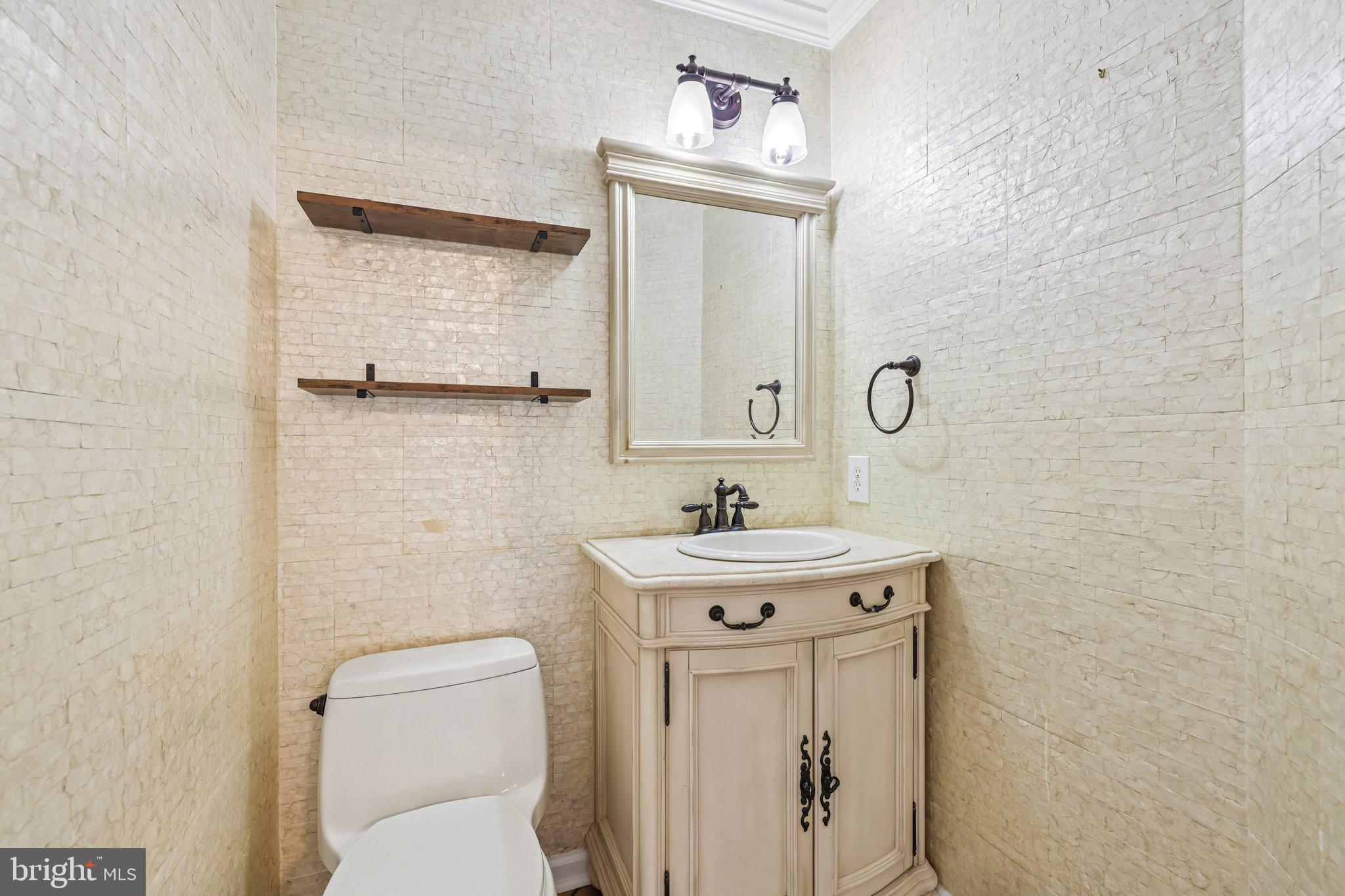 8727 Thornbrook Drive Odenton, MD 21113 - Photo 23 of 40 a bathroom with a toilet a sink and mirror