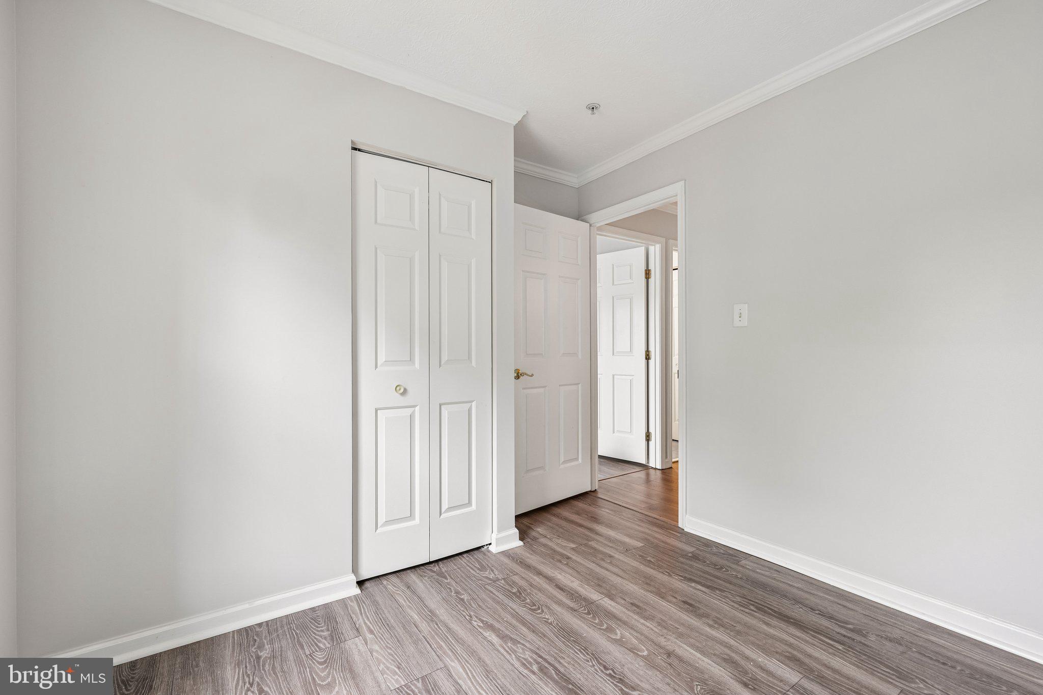 8727 Thornbrook Drive Odenton, MD 21113 - Photo 29 of 40 a view of a hallway with wooden floor
