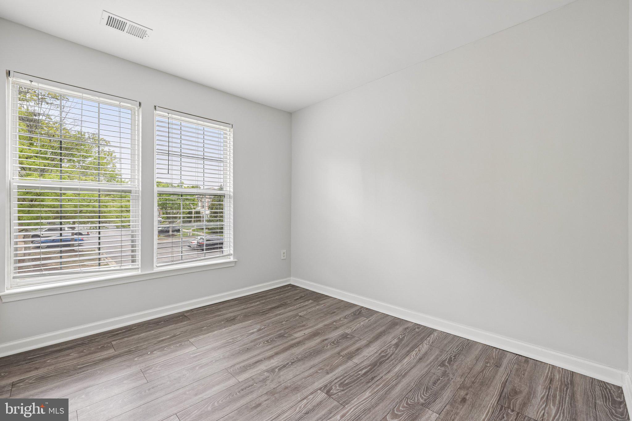 8727 Thornbrook Drive Odenton, MD 21113 - Photo 30 of 40 a view of an empty room with wooden floor and a window