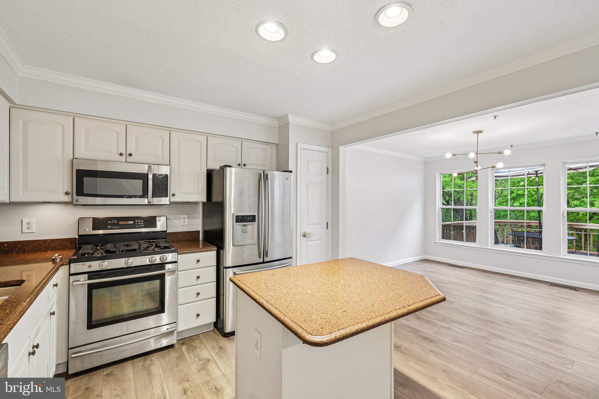 8727 Thornbrook Drive Odenton, MD 21113 - Photo 6 of 40 a kitchen with stainless steel appliances a stove a sink and a refrigerator
