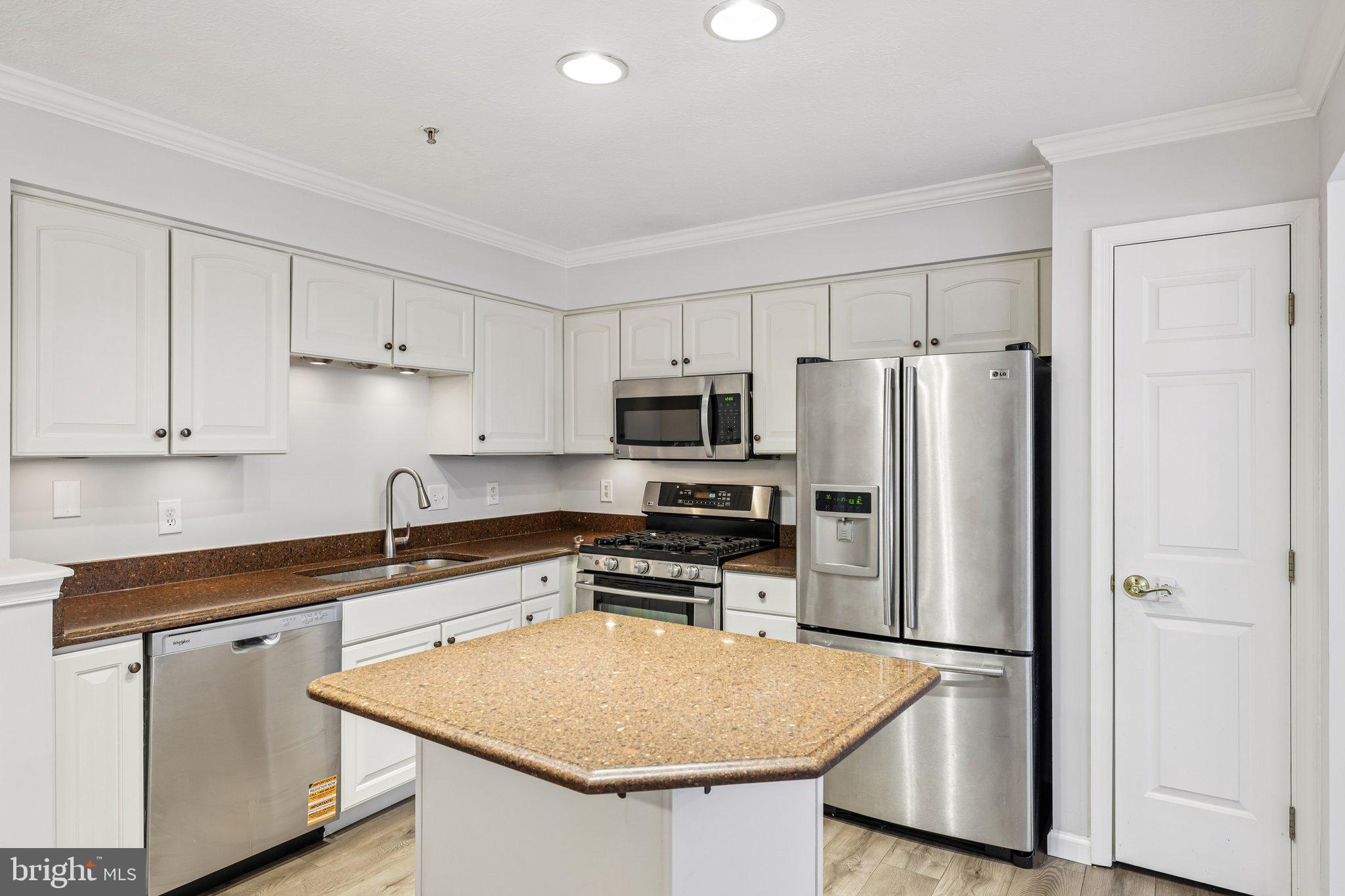 8727 Thornbrook Drive Odenton, MD 21113 - Photo 7 of 40 a kitchen with stainless steel appliances a refrigerator sink and microwave