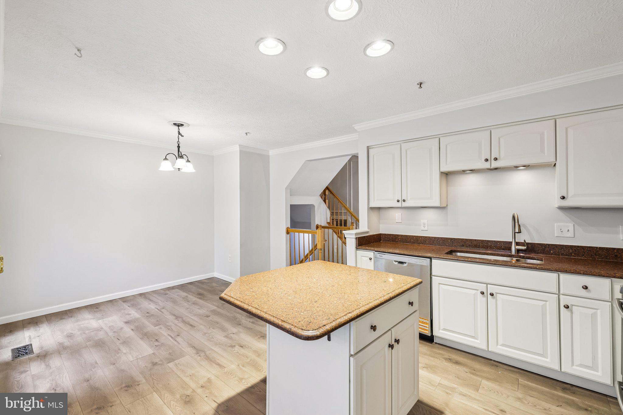 8727 Thornbrook Drive Odenton, MD 21113 - Photo 9 of 40 a kitchen that has a sink a stove and cabinets