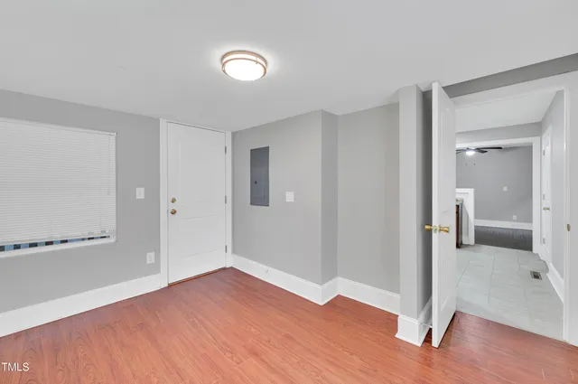 a view of a room with wooden floor