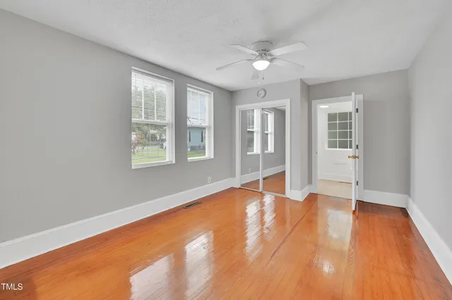 wooden floor in an empty room with a window