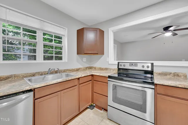 a kitchen with a sink stove and cabinets
