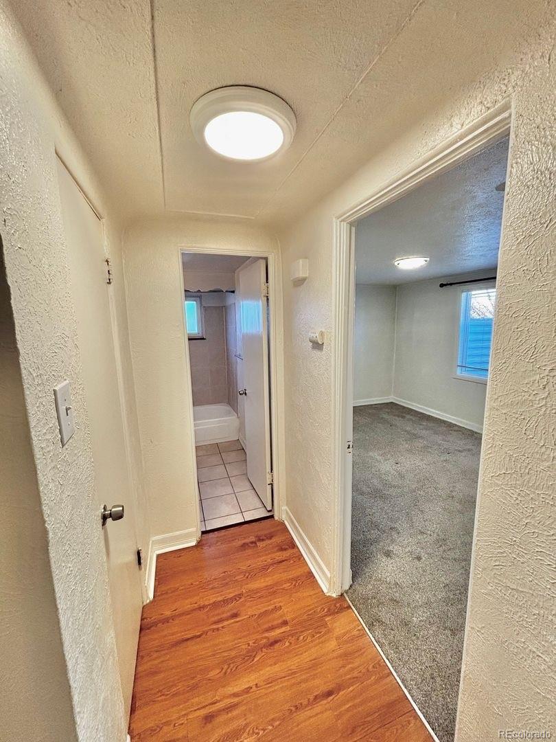 3475 Ames Street, Unit C Wheat Ridge, CO 80212 - Photo 13 of 17 a view of a bedroom from the hallway