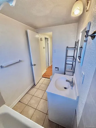 a bathroom with a tub sink and mirror