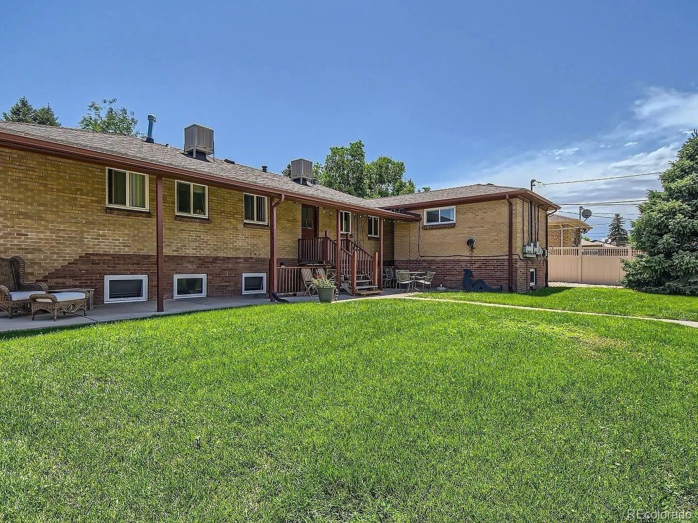 3475 Ames Street, Unit C Wheat Ridge, CO 80212 - Photo 16 of 17 a view of a house with backyard and garden