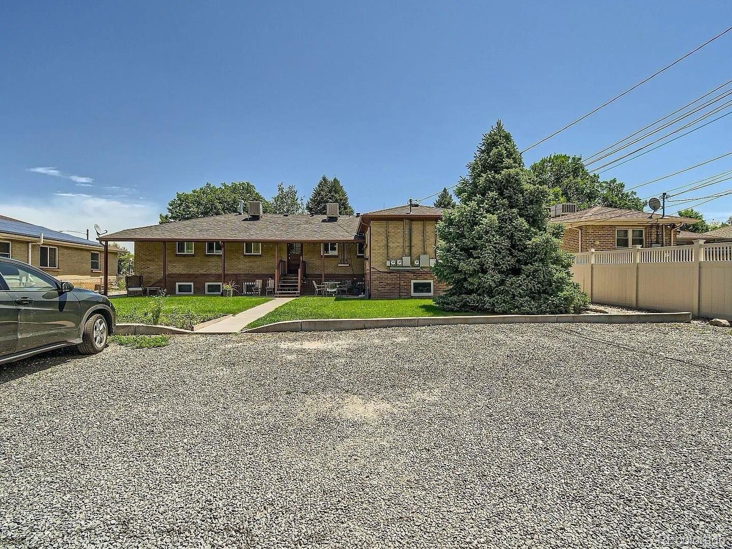 3475 Ames Street, Unit C Wheat Ridge, CO 80212 - Photo 17 of 17 a view of a big house with a big yard and large trees