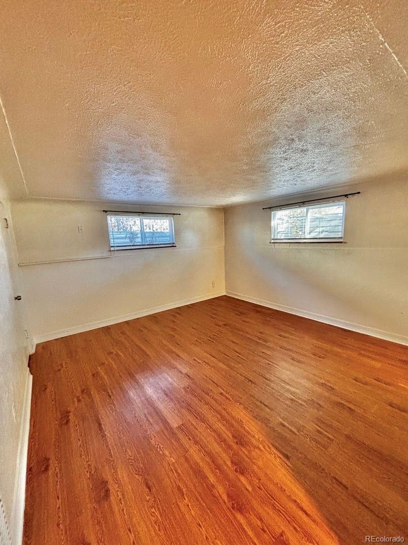 3475 Ames Street, Unit C Wheat Ridge, CO 80212 - Photo 6 of 17 a view of empty room with wooden floor