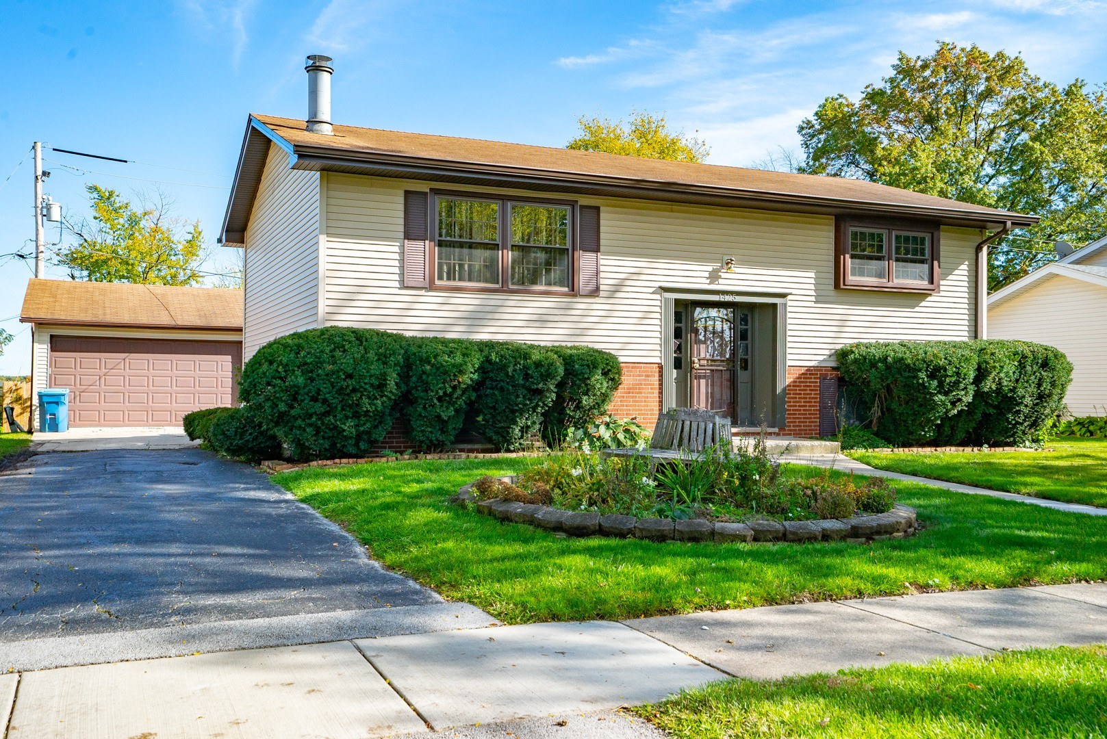 1425 Douglas Lane Crete, IL 60417 - Photo 1 of 19 a front view of a house with a garden
