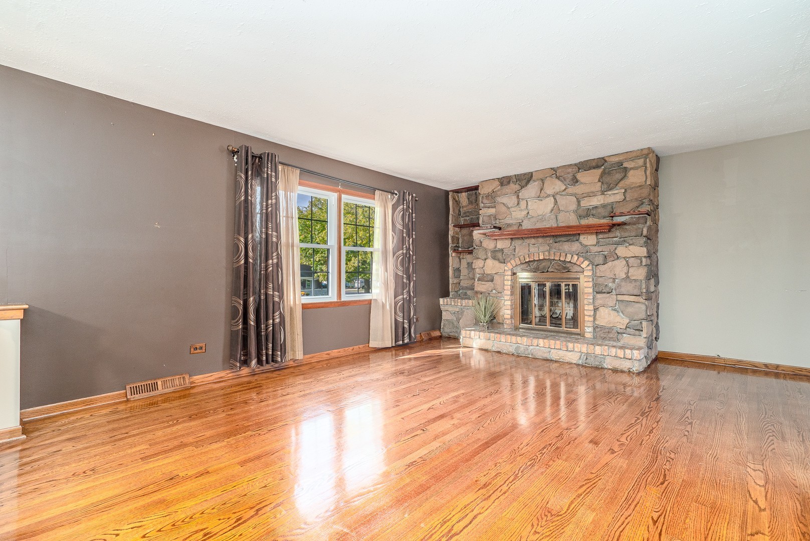 1425 Douglas Lane Crete, IL 60417 - Photo 3 of 19 a view of an empty room with a window and wooden floor