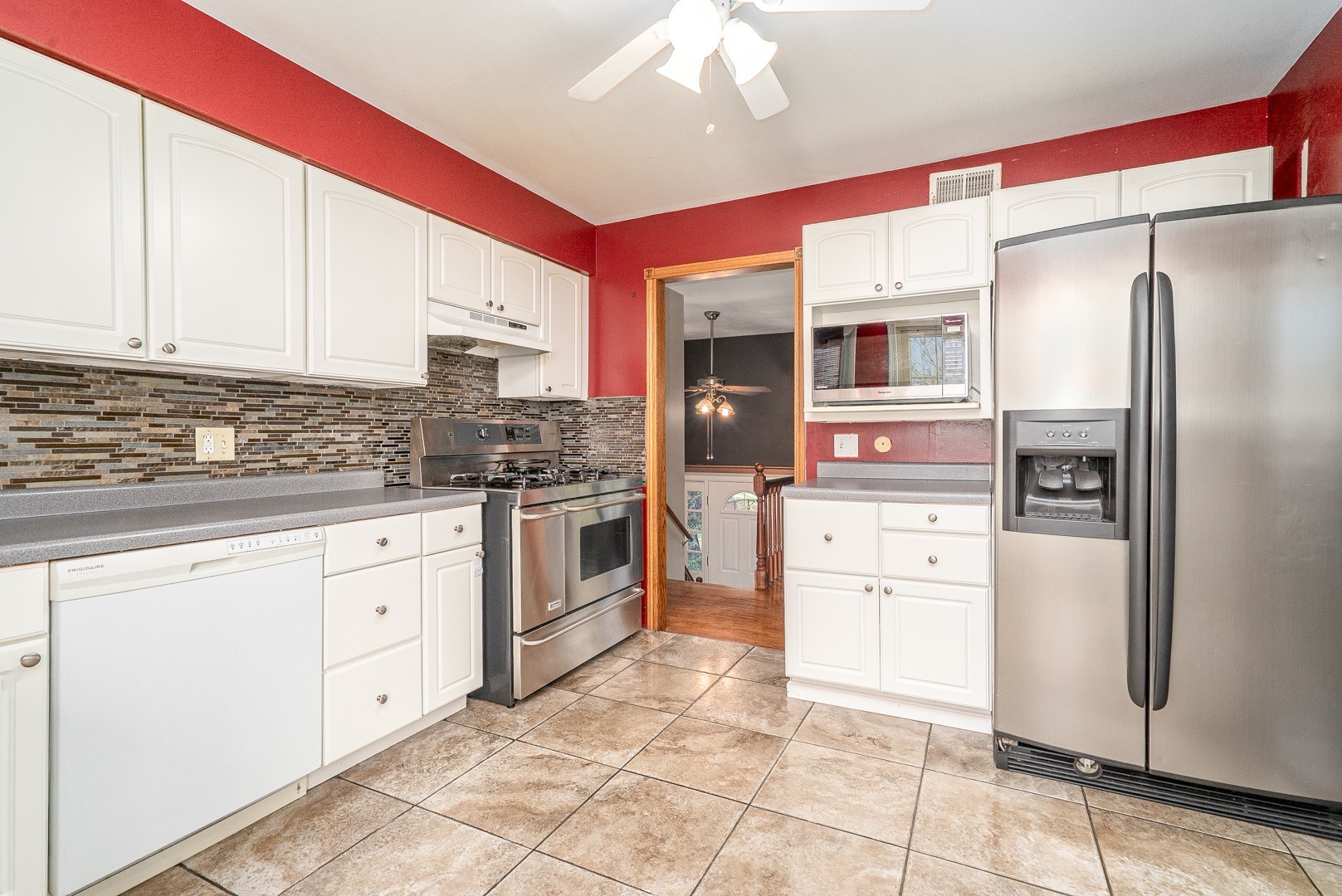 1425 Douglas Lane Crete, IL 60417 - Photo 7 of 19 a kitchen with white cabinets and stainless steel appliances