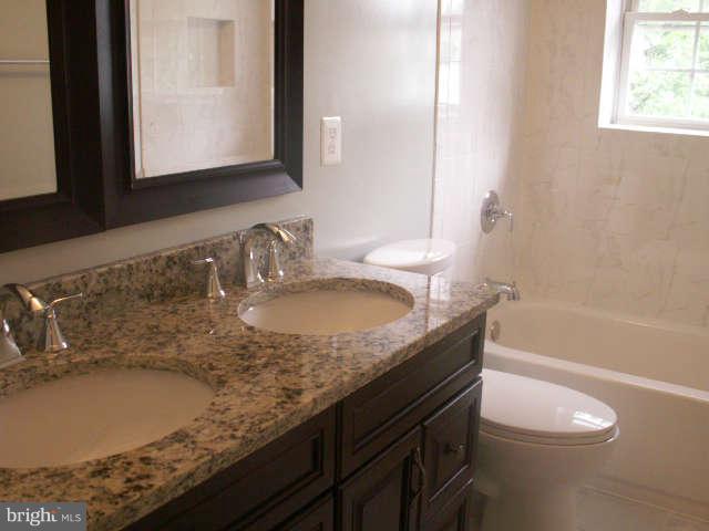 5919 Hanover Avenue Springfield, VA 22150 - Photo 14 of 29 a bathroom with a granite countertop sink toilet and mirror