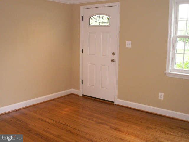 5919 Hanover Avenue Springfield, VA 22150 - Photo 3 of 29 a view of an empty room with wooden floor and a window