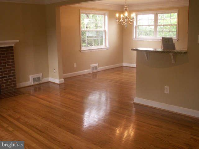 5919 Hanover Avenue Springfield, VA 22150 - Photo 4 of 29 an empty room with wooden floor and windows