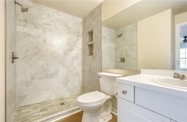 a bathroom with a sink toilet and shower