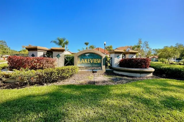 a garden with a bench in front of the house