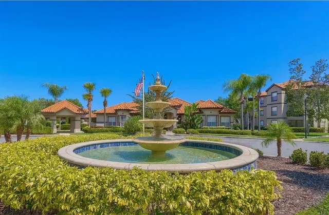 a view of a house with a swimming pool and a yard